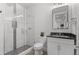Modern bathroom featuring a glass enclosed shower, tile, and vanity with a black countertop at 2745 Java Ct, Denver, CO 80211