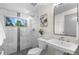 Modern bathroom featuring tiled shower with glass door and a pedestal sink at 2745 Java Ct, Denver, CO 80211