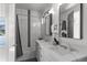 Stylish bathroom featuring marble finishes, dual sinks, and a shower-tub combo at 2745 Java Ct, Denver, CO 80211