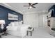 This is a cozy bedroom with a ceiling fan, fireplace and ensuite bathroom at 2745 Java Ct, Denver, CO 80211