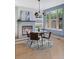 Cozy dining area featuring a fireplace, stylish lighting, and a large window at 2745 Java Ct, Denver, CO 80211