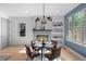 Inviting dining area with hardwood floors, a modern fireplace, and a sunny window at 2745 Java Ct, Denver, CO 80211