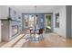 Comfortable dining space with fireplace, large window, and access to the outdoor area at 2745 Java Ct, Denver, CO 80211