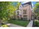 Modern multi-story exterior with stone facade, balconies, and landscaping at 2745 Java Ct, Denver, CO 80211