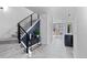 Spacious foyer featuring a modern staircase, open floor plan, and access to the dining room at 2745 Java Ct, Denver, CO 80211