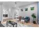Bright living room showcasing stylish seating, hardwood floors, and an open layout leading to the kitchen at 2745 Java Ct, Denver, CO 80211