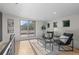 Bright sitting area with modern chairs, hardwood floors and a sliding door leading to a deck at 2745 Java Ct, Denver, CO 80211
