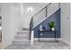 Modern staircase design with metal railing and blue accent wall and stylish console table with decor at 2745 Java Ct, Denver, CO 80211