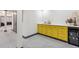 Basement bar featuring yellow cabinets with a wine fridge and serving area at 14938 Vienna Cir, Parker, CO 80134