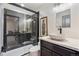 Modern bathroom featuring a unique vessel sink, stylish fixtures, and glass-enclosed shower with mosaic tiling at 14938 Vienna Cir, Parker, CO 80134