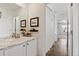 Bathroom featuring a white vanity with marble countertop, decorative mirror, and tile flooring at 14938 Vienna Cir, Parker, CO 80134