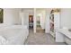 Bedroom with neutral walls, carpet, a wardrobe, and hallway with tile flooring view at 14938 Vienna Cir, Parker, CO 80134