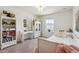 Bright bedroom features soft carpet, a white bed frame, and a stylish writing desk at 14938 Vienna Cir, Parker, CO 80134