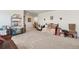 Bonus room with neutral walls and carpet featuring a large daybed with decorative pillows at 14938 Vienna Cir, Parker, CO 80134