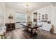 Elegant dining room featuring a modern chandelier, hardwood floors, and stylish decor at 14938 Vienna Cir, Parker, CO 80134