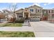 Charming two-story home featuring a covered porch, well-manicured lawn, and an attached two-car garage at 14938 Vienna Cir, Parker, CO 80134