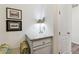 Hallway nook with granite countertop, small cabinet, drawers, framed artwork, and an adjacent doorway at 14938 Vienna Cir, Parker, CO 80134
