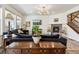 Bright living room featuring hardwood floors, a fireplace, and an open layout into the kitchen at 14938 Vienna Cir, Parker, CO 80134