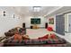 Spacious living room with plush seating, modern lighting, and a large screen TV for entertainment at 14938 Vienna Cir, Parker, CO 80134
