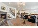 Open-concept living room with a fireplace, hardwood floors, and staircase access at 14938 Vienna Cir, Parker, CO 80134