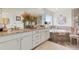Main bathroom features double sinks, granite countertops, soaking tub, and walk-in shower at 14938 Vienna Cir, Parker, CO 80134