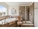 View of the tiled main bathroom with soaking tub and walk-in shower at 14938 Vienna Cir, Parker, CO 80134