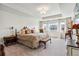 Spacious main bedroom features a tray ceiling, a large bed, bench and two bedside tables at 14938 Vienna Cir, Parker, CO 80134