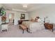 The main bedroom is spacious with large bed, bench, side tables and artwork at 14938 Vienna Cir, Parker, CO 80134