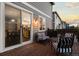 The back deck with chairs, a grill, and sliding glass doors into the dining room and kitchen at 7536 Grady Cir, Castle Rock, CO 80108