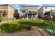 A sprawling backyard with a lush green lawn, deck, and a play structure offers outdoor fun at 7536 Grady Cir, Castle Rock, CO 80108