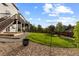 A large backyard with a play structure and a deck with stairs leading down from the second story at 7536 Grady Cir, Castle Rock, CO 80108