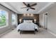 Primary bedroom with accent wall, ceiling fan, and access to en-suite bathroom at 7536 Grady Cir, Castle Rock, CO 80108
