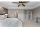 Primary bedroom with accent wall, ceiling fan, and multiple doors to other rooms at 7536 Grady Cir, Castle Rock, CO 80108