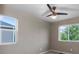 A well lit bedroom with a fan, two windows, and carpet at 7536 Grady Cir, Castle Rock, CO 80108