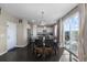 Bright dining area with dark wood floors, a table, and access to a deck with views at 7536 Grady Cir, Castle Rock, CO 80108