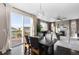 Well-lit dining area with deck access, seamlessly connecting to an inviting living room with a fireplace and backyard view at 7536 Grady Cir, Castle Rock, CO 80108