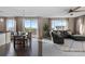 Open dining and living area with dark wood floors, a dining table, and a sliding glass door to the deck at 7536 Grady Cir, Castle Rock, CO 80108