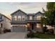 Charming two-story home with a gray exterior, well-maintained lawn, and a two-car garage at 7536 Grady Cir, Castle Rock, CO 80108