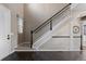 Elegant foyer featuring a staircase with carpet, dark wood floors, and natural light at 7536 Grady Cir, Castle Rock, CO 80108