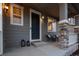 Cozy front porch featuring stone supports, a seating area, and a welcoming entrance at 7536 Grady Cir, Castle Rock, CO 80108