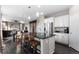 Open kitchen with an island featuring barstool seating, modern stainless steel appliances, and seamless connectivity to living spaces at 7536 Grady Cir, Castle Rock, CO 80108