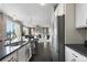 Modern kitchen features a central island, stainless steel appliances, and a seamless transition to the living and dining areas at 7536 Grady Cir, Castle Rock, CO 80108