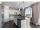Bright kitchen with white cabinets, granite countertops, stainless steel appliances, and a center island with barstool seating at 7536 Grady Cir, Castle Rock, CO 80108