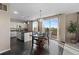 Open kitchen with an island and stainless steel appliances, seamlessly connecting to the dining area with a lovely backyard view at 7536 Grady Cir, Castle Rock, CO 80108