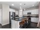 Bright kitchen featuring an island with barstool seating, stainless steel appliances, and modern cabinetry with granite countertops at 7536 Grady Cir, Castle Rock, CO 80108