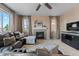 Cozy living room featuring a fireplace, large windows, and plush seating at 7536 Grady Cir, Castle Rock, CO 80108