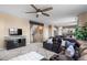 Comfortable living room featuring a plush sectional sofa, ceiling fan, and an open concept to the kitchen at 7536 Grady Cir, Castle Rock, CO 80108