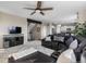 Open-concept living space with a sectional sofa, television, and view of kitchen with white cabinets at 7536 Grady Cir, Castle Rock, CO 80108