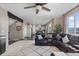 Spacious living area with a ceiling fan, a comfortable leather sofa, and an open view to the kitchen at 7536 Grady Cir, Castle Rock, CO 80108