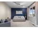 Comfortable living room with neutral carpet, a striking blue accent wall, and a large window at 7536 Grady Cir, Castle Rock, CO 80108